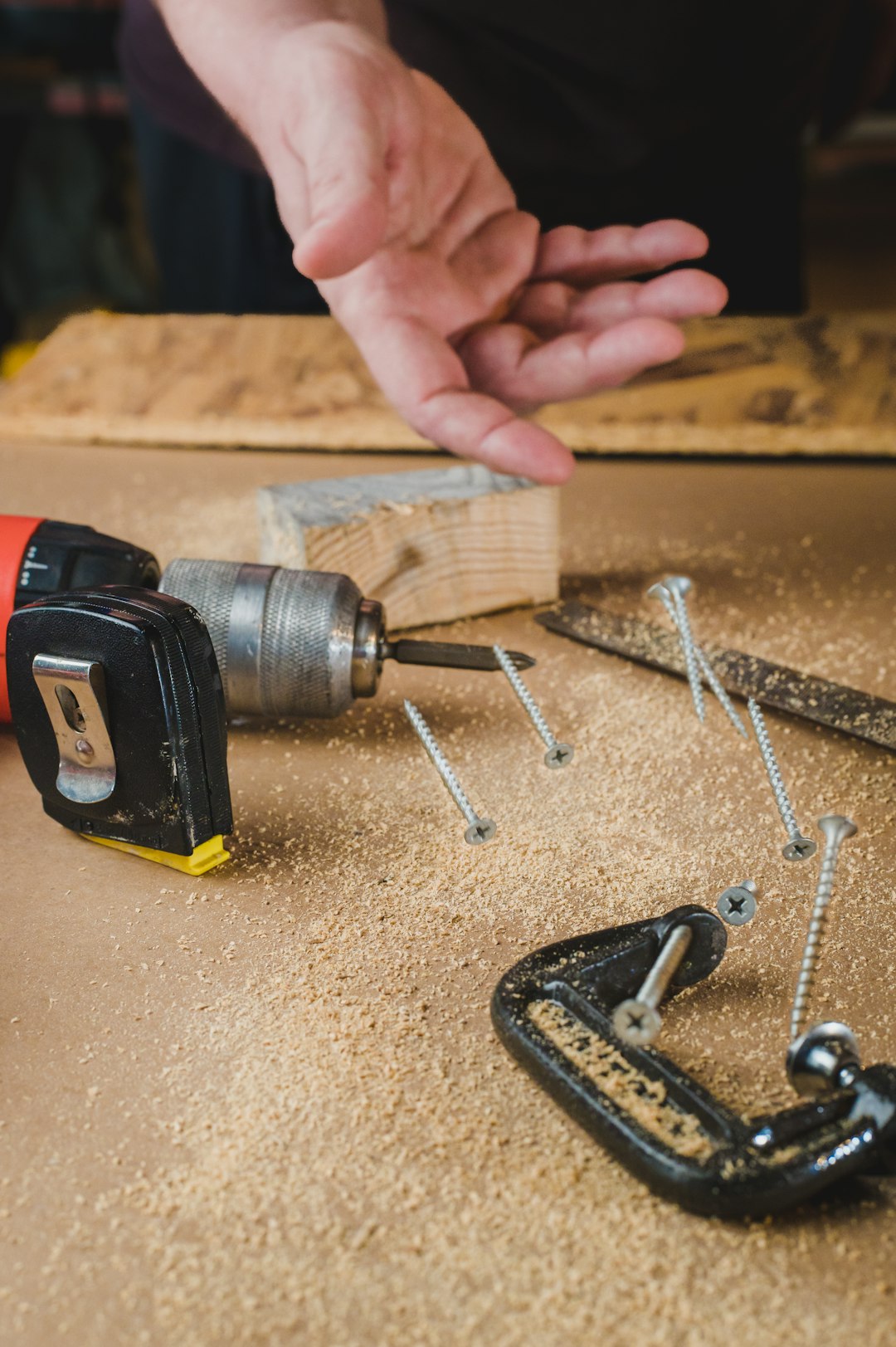 services-04 Carpenter throws screws on a workbench.